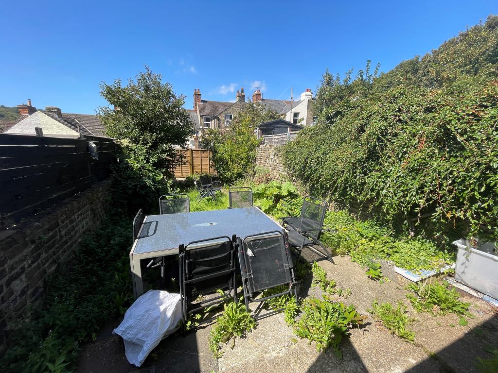 Lot: 119 - BAY-FRONTED HOUSE FOR INVESTMENT - Garden with patio and grass area